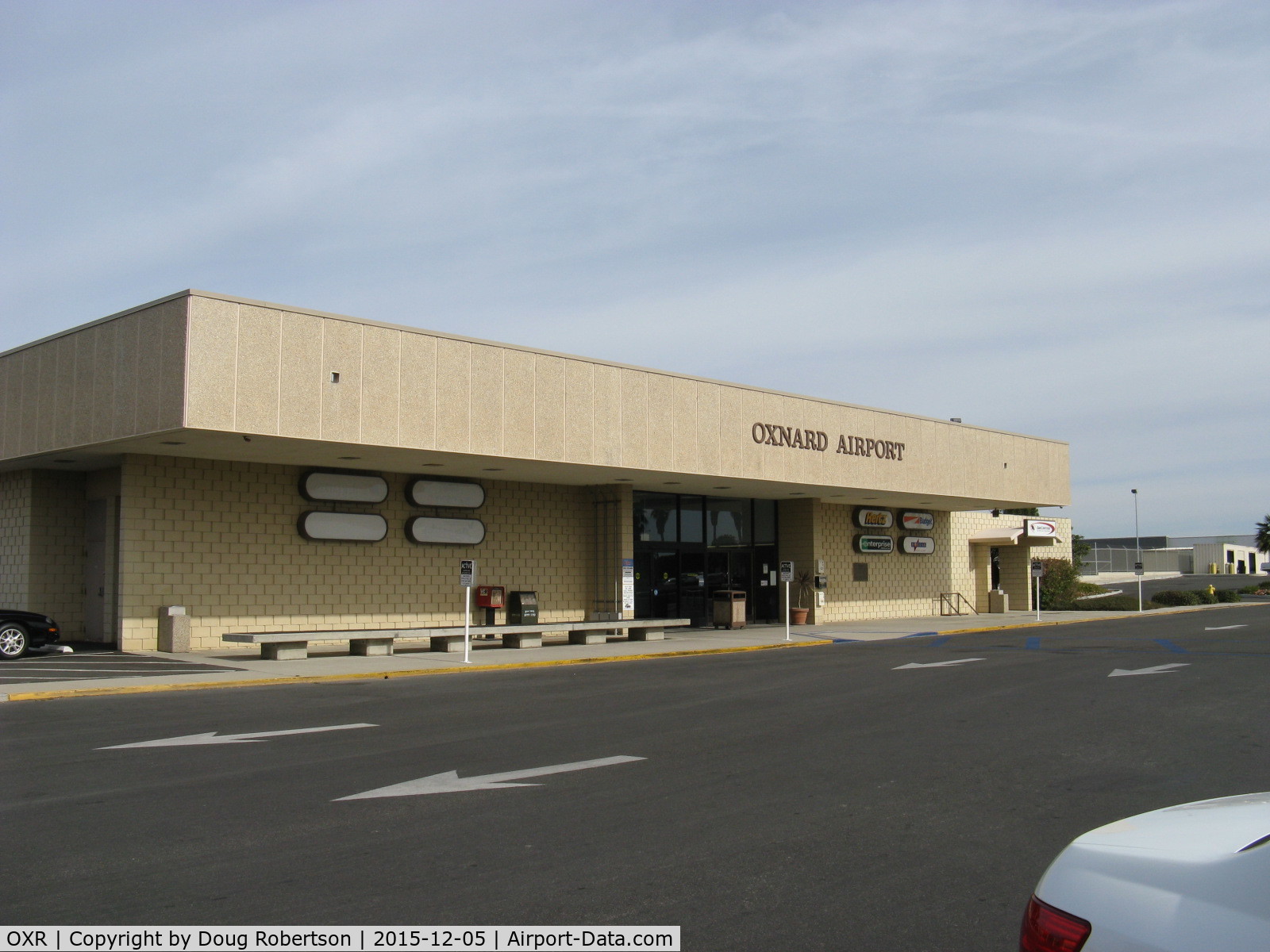 Oxnard Airport (OXR) - Oxnard Airport Terminal Building. No commercial commuter passenger flights have been offered to/from OXR since Summer 2010. The terminal only provides various rental vehicle services. Note the four blank placards.
