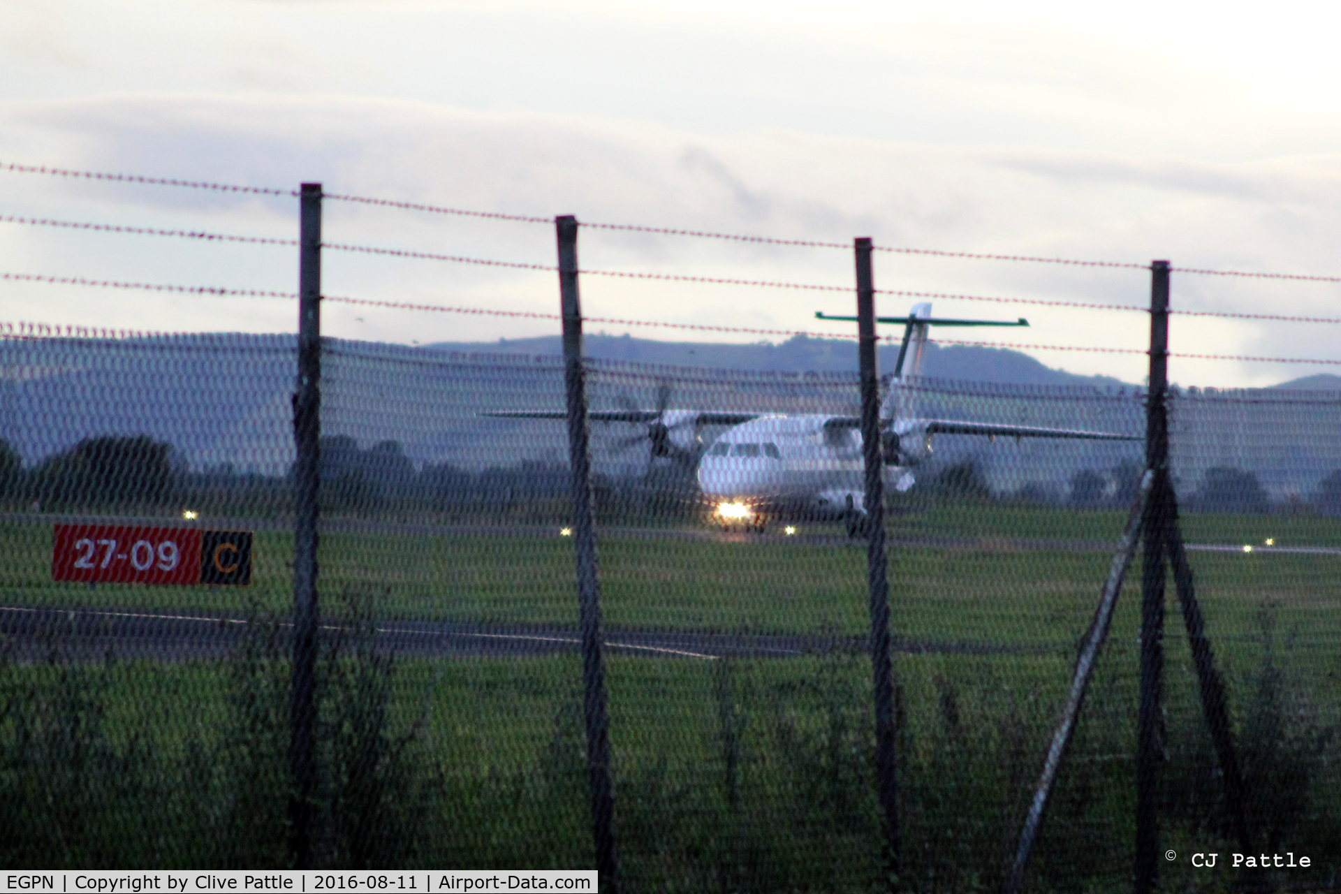 Dundee Airport, Dundee, Scotland United Kingdom (EGPN) - Through the fence shot in the failing light at Dundee EGPN - Dornier Do328-100 G-BYHG back tracks to the terminal.