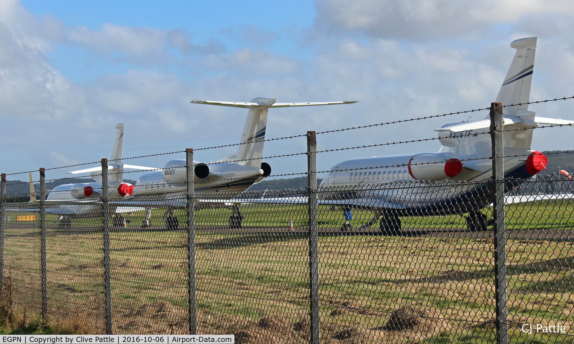 Dundee Airport, Dundee, Scotland United Kingdom (EGPN) - Through the fence - Bizjets parked up on the taxyway at Dundee Riverside Airport EGPN for the Annual Dunhill Golf Championships, held at nearby St Andrews. 