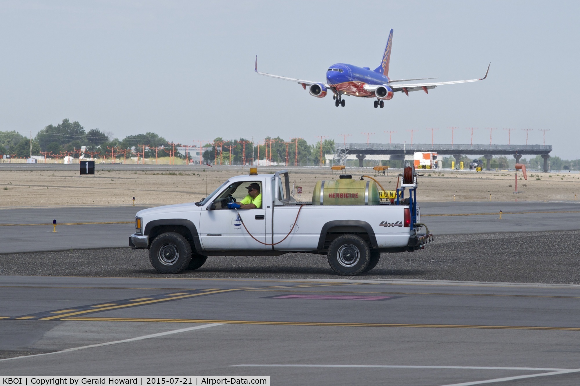 Boise Air Terminal/gowen Fld Airport (BOI) - Outside maintenance crews spraying to keep the weeds at bay. A never ending job.