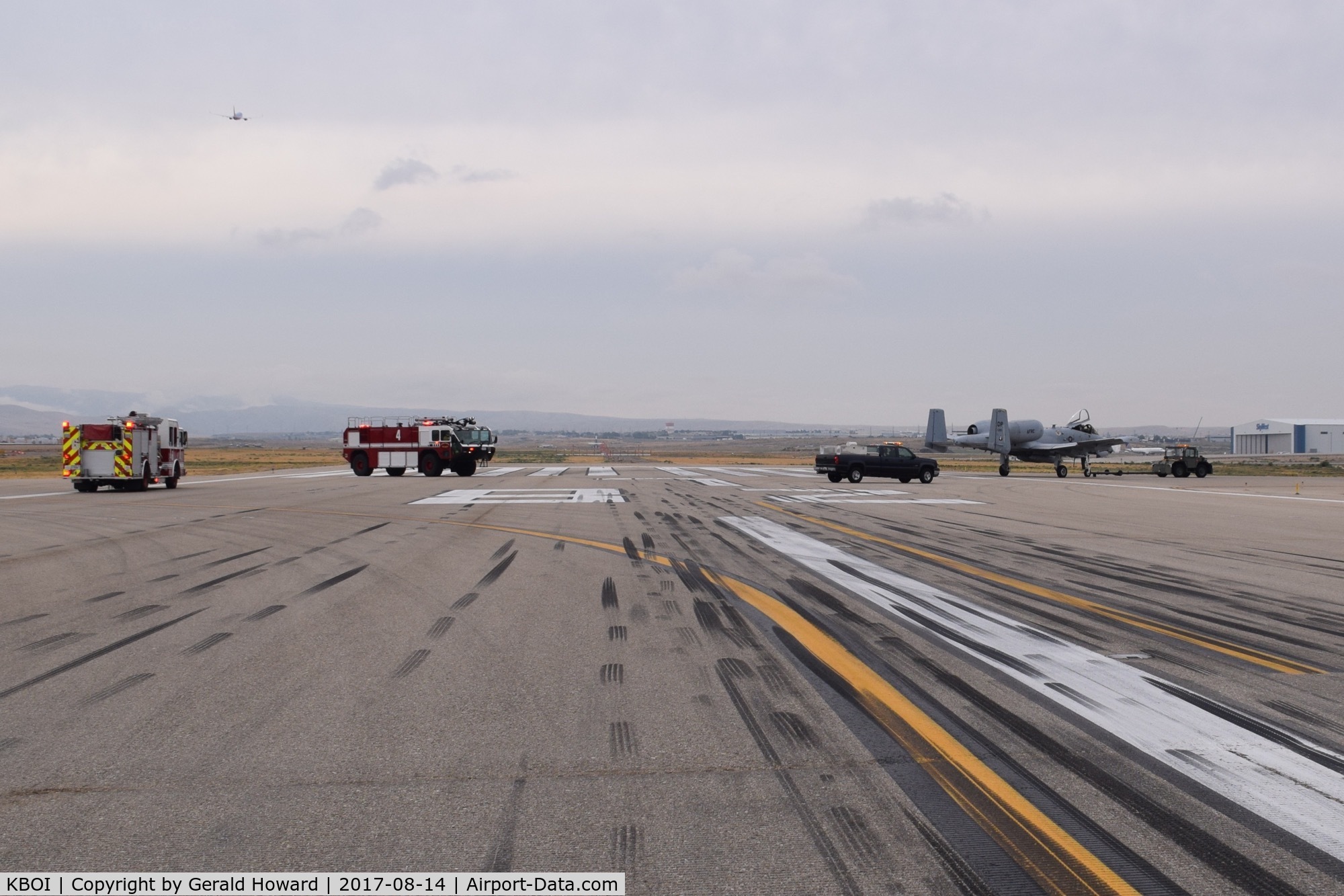 Boise Air Terminal/gowen Fld Airport (BOI) - Disabled A-10 being towed off runway followed by emergency equipment.