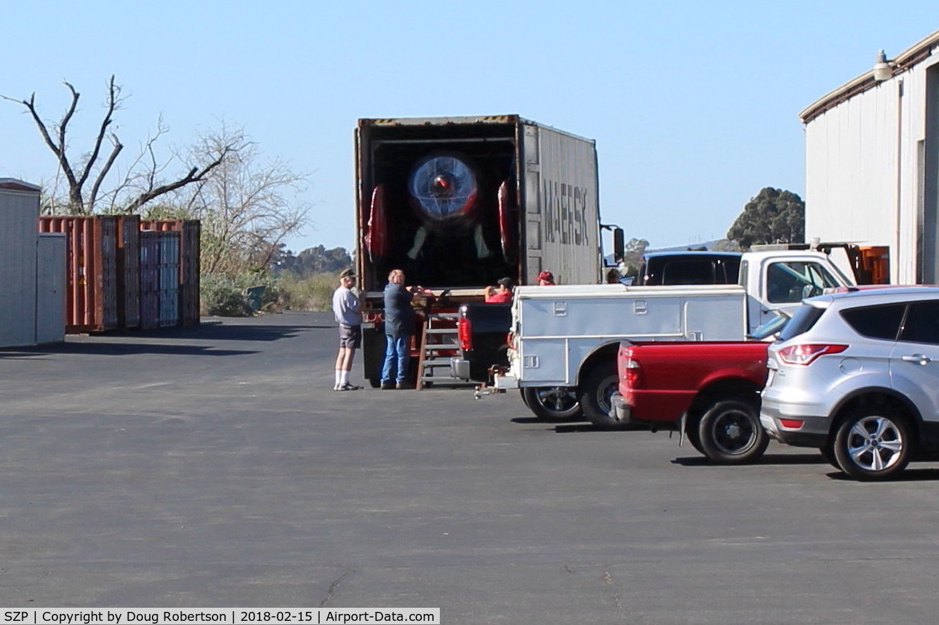 Santa Paula Airport (SZP) - MAERSK LINE arrival truck to unload Kimball PITTS Model 12 biplane aircraft for reassembly. Maersk  is largest international shipper using ocean freighters. Location-behind Ray's Aviation. Some ocean freight containers in left side past Tee Hangar.