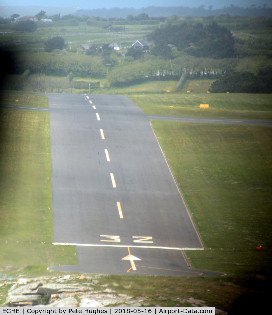 St. Mary's Airport, St. Mary's, England United Kingdom (EGHE) - Short finals for 32 St Marys Isles of Scilly in Twin Otter G-CEWM.  Since my 1987 pictures (qv) the grass has been replaced by tarmac runway.  The slope here is quite apparent, see also the shots at ground level from the threshold.