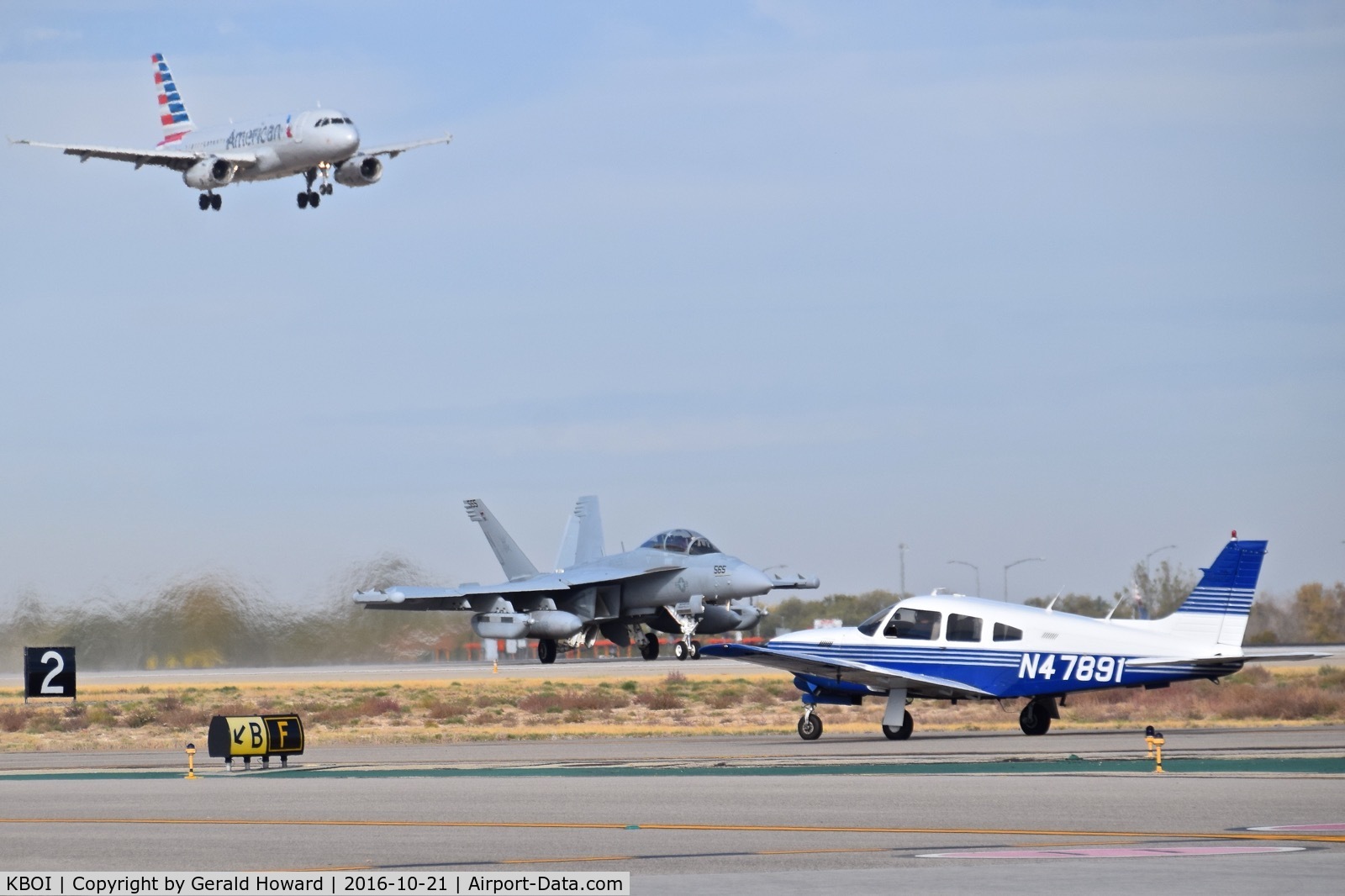 Boise Air Terminal/gowen Fld Airport (BOI) - A Piper on Taxiway Foxtrot while an EA-18G takes off on RWY 10R and American Airlines lands on RWY 10L.