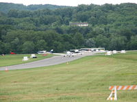 Frederick Municipal Airport (FDK) - This was the line for departure from the 2006 AOPA Fly-In.  If that was my house I would have a deck on the roof and sit and watch the antics on the runway everyday.  FDK is MD's second busiest airport that makes for some pretty good antics. - by Sam Andrews