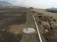 Santa Paula Airport (SZP) - New aircraft tiedown pads set in concrete-tail tiedown pads-Santa Clara River bank right adjacent-Note really muddy fast & high waters! - by Doug Robertson