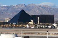 Mc Carran International Airport (LAS) - Looking west from the airport's main parking structure, you get a nice view of the Luxor Hotel & Casino and the mountains. - by Dean Heald