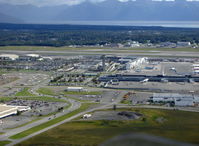 Ted Stevens Anchorage International Airport (ANC) - Approaching abeam ANC Tower and South Terminal for landing Lake Hood Sea Plane Base LHD. Water in distance is Turnagain Arm. Taken from copilot's seat DHC-2 Beaver float plane N4444Z. - by Doug Robertson