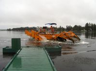 Lake Hood Seaplane Base (LHD) - Lake Hood SPB's water weed cutter/scooper keeping busy clearing taxi lanes-scooper raised - by Doug Robertson