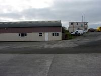 Bodmin Airfield - Control Tower and side of main hangar - by Terry Fletcher