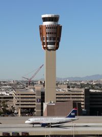 Phoenix Sky Harbor International Airport (PHX) - Good definition of scale between the A319 and the new control tower. The crane in the background is dismantling the old tower. - by John Meneely