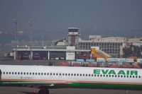 Kaohsiung International Airport, Kaohsiung City Taiwan (RCKH) - The airport firefighter building can be seen behind the MD-90 from EVA Air - by Michel Teiten ( www.mablehome.com )