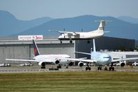 Vancouver International Airport, Vancouver, British Columbia Canada (YVR) - DHC-8 landing while one 767 and one A340 are waiting for take-off - by Michel Teiten ( www.mablehome.com )