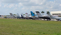 Fort Lauderdale Executive Airport (FXE) - Aview down World Jet's ramp at Ft.Lauderdale Executive reveals a diverse ramp of aircraft types , some of which now fall into the 'classic' category - by Terry Fletcher
