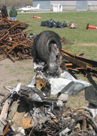 Crystal Airport (MIC) - The remains of a Piper PA-28 after a hangar fire.  Note the fiberglass cloth from the nose wheelpant survived, but the resin has melted away. - by Timothy Aanerud