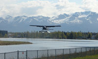 Lake Hood Seaplane Base (LHD) - A DHC2 Beaver takes off from Spenard Lake end against a beautiful backdrop - by Terry Fletcher
