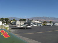 Santa Paula Airport (SZP) - Taxi past mid-field self-service fuel dock, CP Aviation FBO beyond. - by Doug Robertson