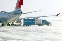 The Eastern Iowa Airport (CID) - U of I football team baggage truck unloading onto NWA9980 - by Glenn E. Chatfield