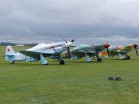 Duxford Airport, Cambridge, England United Kingdom (EGSU) - Beautiful line of Yak-fighters waiting for the action at the Legends 2009 - by Alex Smit