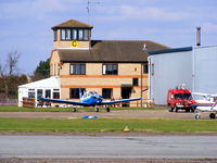 Peterborough Business Airport - Tower and club house at Conington with PA-28 G-LSFI - by Chris Hall