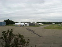 Sanga-Sanga Airport - Aircraft Hangars, taxiway in foreground - by Doug Robertson
