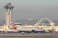 Los Angeles International Airport (LAX) - BA 744 taxiing out on the south complex with a VA A320 landing on the north side. - by Mark Kalfas
