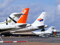 London Luton Airport - line of tails at Luton Airport - by Chris Hall