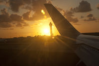 Miami International Airport (MIA) - The sun sets at MIA (from a 767) - by Mauricio Morro