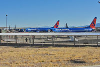 Laughlin/bullhead International Airport (IFP) - Two Sun Country B737s and Three US Marines Hercules on the Bullhead / Laughlin apron - by Terry Fletcher
