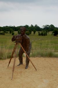 First Flight Airport (FFA) - Sculpture of John Daniels at the Wright Brothers National Memorial, Kill Devil Hills, NC - by scotch-canadian