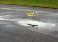 Santa Paula Airport (SZP) - Rick's Tiger Moth RC drone puddle jumper, reflected in flight - by Doug Robertson