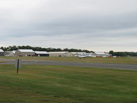 Sanga-Sanga Airport - Aircraft hangars, windsock, taxiway in foreground - by Doug Robertson