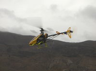 Santa Paula Airport (SZP) - Rick's RC drone T-REX helicopter, maneuvering, note trailing antenna - by Doug Robertson