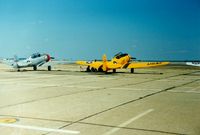 Quonset State Airport (OQU) - North America AT-6 Texan N6984C and North American AT-6 Texan 51-14987 at Quonset State Airport, North Kingstown, RI - circa 1980's - by scotch-canadian