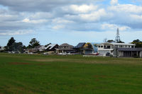 Pauanui Beach Aerodrome - Houses with hangar downstairs, looking onto the runway! How beautiful is that? - by Micha Lueck