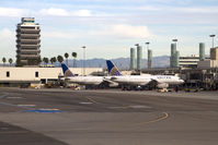 Los Angeles International Airport (LAX) - A pair of United Airlines aircraft parked at Terminal 8. The control tower on the left was in use from October 1962 to April 1996. - by Dean Heald