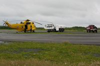 Swansea Airport, Swansea, Wales United Kingdom (EGFH) - RAF SAR Sea King taking on fuel with Fire and Rescue tender (FIRE 2) in attendence. - by Roger Winser