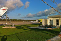 Treasure Cay Airport - A peek at the airfield through the fence - by Murat Tanyel