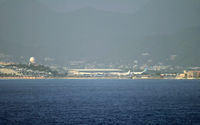 Princess Juliana International Airport, Philipsburg, Sint Maarten Netherlands Antilles (TNCM) - This is what SXM looks like from way out at sea; the famous Maho Beach from which people photograph low-flying aircraft is visible. - by Daniel L. Berek