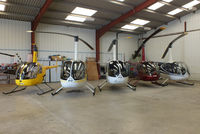 Wellesbourne Mountford Airfield Airport, Wellesbourne, England United Kingdom (EGBW) - from L to R, G-BLME, G-MISK, G-MENU, G-JTSA and G-OJRH inside the Heli Air hangar - by Chris Hall