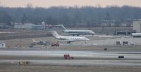 Detroit Metropolitan Wayne County Airport (DTW) - Across the ramp - Little Caesars Gulfstream II, former Detroit Pistons DC-9s, an O-2 that doesn't look flyable and a Cessna 172 - oh yeah and behind that The Playhouse Nudie Bar - by Florida Metal