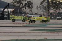 Los Angeles International Airport (LAX) - LAX ARFF 80 and ARFF 280 escorting an aircraft to the American Maintenance Hangar. 
 - by Mark Kalfas