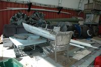Shell Creek Airpark Airport (F13) - Various Douglas DC-3 parts in the open hangar. - by Carl Byrne (Mervbhx)