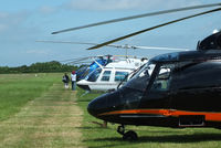 Turweston Aerodrome Airport, Turweston, England United Kingdom (EGBT) - line up of helicopters being used for ferrying race fans to the British F1 Grand Prix at Silverstone - by Chris Hall