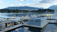 Vancouver Harbour Water Airport (Vancouver Coal Harbour Seaplane Base) - Early overcast Sunday morning at Harbour Air terminal in Coal Harbour.  Stanley Park and the North Shore mountains are in the background. - by M.L. Jacobs