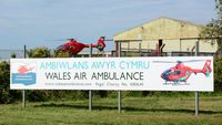 Swansea Airport, Swansea, Wales United Kingdom (EGFH) - Sign by the entrance to Swansea Airport showing the charity (Wales Air Ambulance) funding the three air ambulance helicopters operating in Wales. The Swansea based air ambulance helicopter (Helimed 57) is responding to an emergency - by Roger Winser