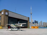 Toronto City Centre Airport - Showing the old hangar and skyline behind. - by Ray Barber