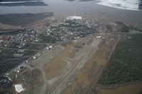Fort Yukon Airport (FYU) - Fort Yukon, Alaska.  Minor flooding of ramp during breakup of Yukon River.  Taken from Wright Air N4637U piloted by Dave Lorring. - by David Lee