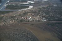 Fort Yukon Airport (FYU) - Fort Yukon, Alaska.  Minor flooding of ramp during breakup of Yukon River.  (River seen in picture flows into the Yukon which is to the left of the image)  Taken from Wright Air N4637U piloted by Dave Lorring. - by David Lee