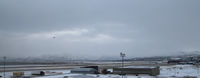 Alta Airport, Alta, Finnmark Norway (ENAT) - Alta's runway viewed across dockside buildings; terminal to rear right of picture. - by Pete Hughes